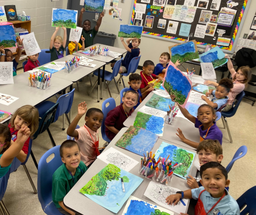 elementary art students show off their water colors paintings at Lakeside Christian School