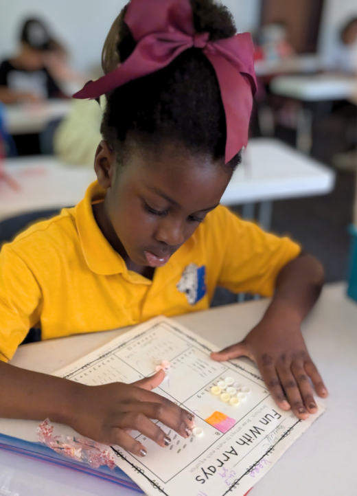 elementary student  at Lakeside Christian School in Clearwater, Fl completes a hands on math assignment