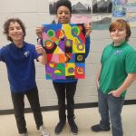 Lakeside Christian School students proudly display their colorful art project during class.