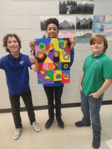Lakeside Christian School students proudly display their colorful art project during class.